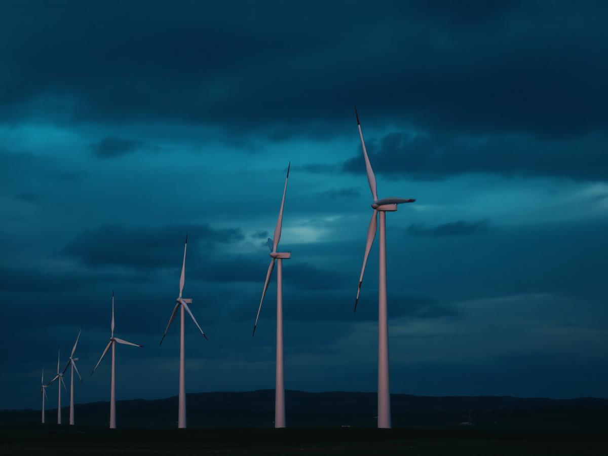 Renewable energy site with wind turbines at dusk